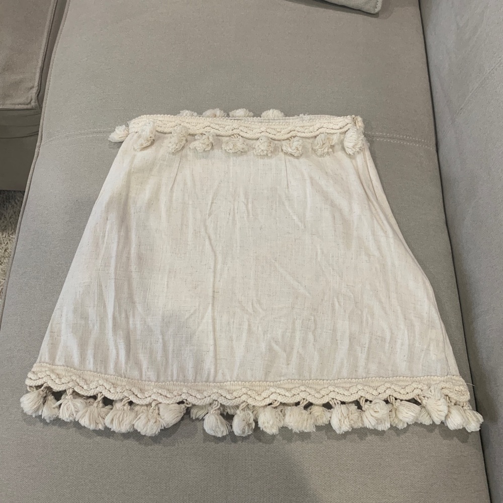 Cream linen skirt with Pom Pom hem. Size small.